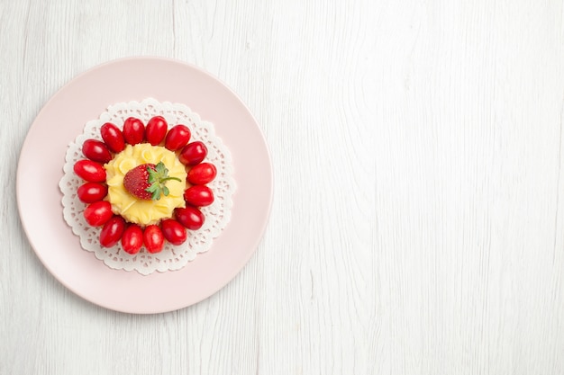 Top view yummy cream cake with dogwoods on the white desk