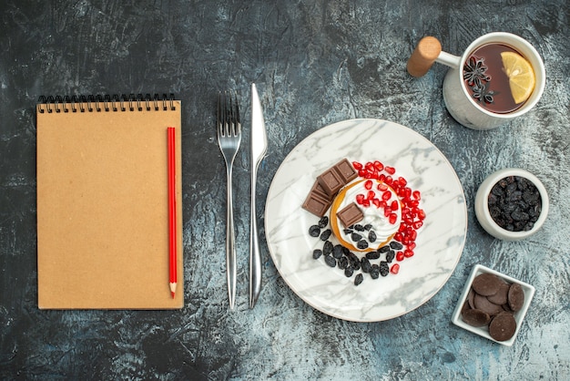 Top view yummy creamy cake with cup of tea on light-dark background