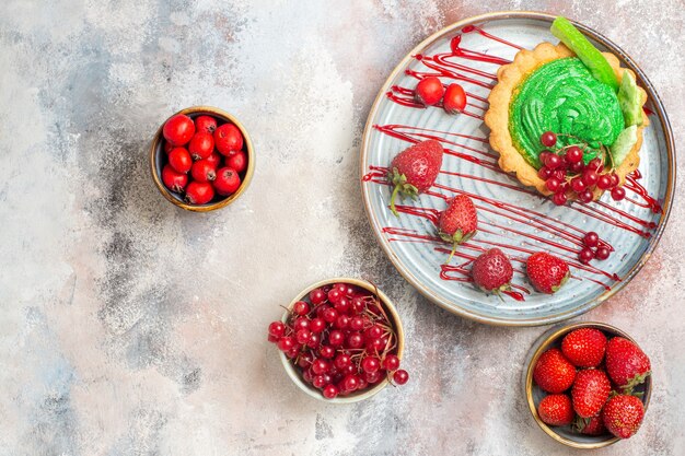 Top view yummy creamy cake with fresh fruits on a light table biscuit dessert cake sweet