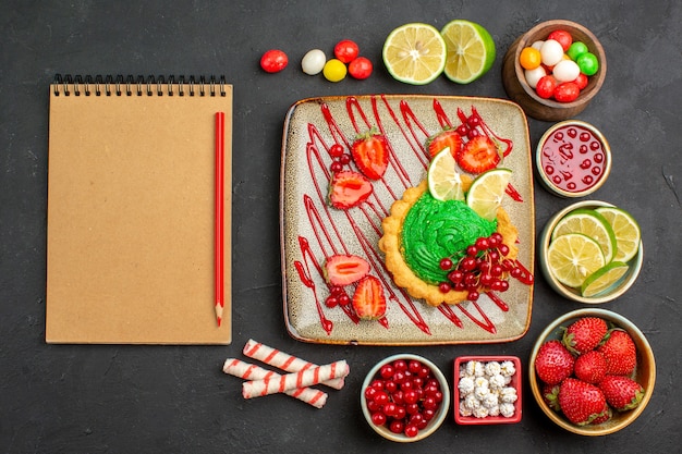 Top view yummy creamy cake with fruits on dark background biscuit dessert sweet color