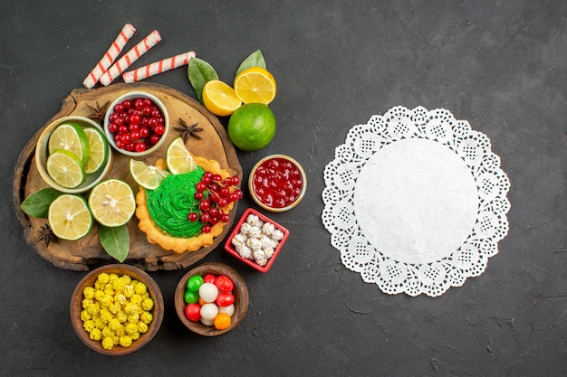 Top view yummy creamy cake with fruits on dark background sweet biscuit cookie photo