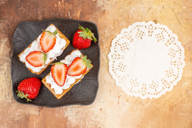 Free photo top view yummy creamy cakes with fruits on light background