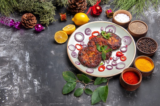 Top view yummy cutlets with onion rings on a grey background dish meat meal photo