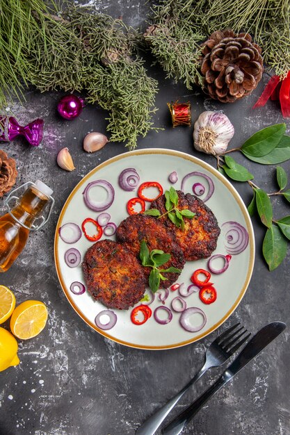 Top view yummy cutlets with onion rings on grey desk meat dish meal photo