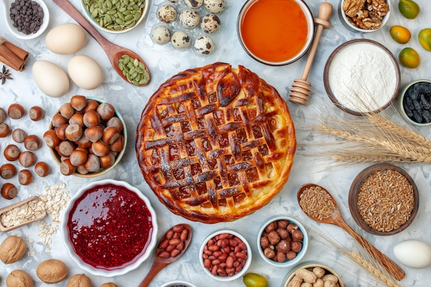 Top view yummy fruity pie with nuts and eggs on light bake biscuit pie dessert tea cake cookie bakery bun