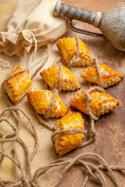 Top view of yummy nut pastries with ropes on a brown background