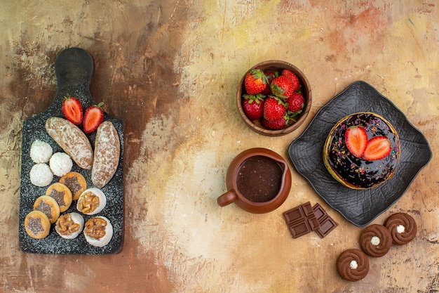 Free Photo top view yummy pancakes with sweets and fruits on wooden desk