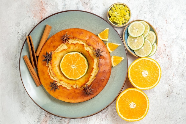 Free Photo top view yummy pie delicious dessert for tea with lemon and orange on a white background fruit cake pie tea biscuit sweet dessert