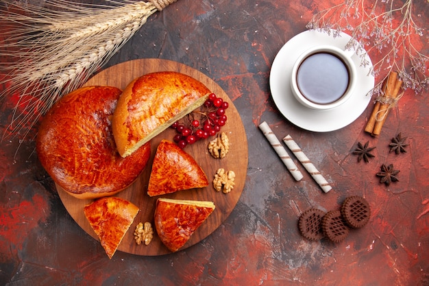 Top view of yummy pies sliced with red berries