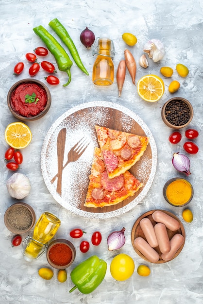 Free photo top view yummy pizza slices with fresh vegetables on a white table