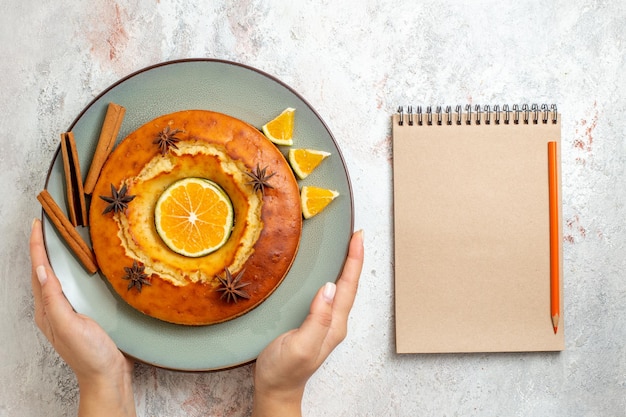 Free Photo top view yummy round pie delicious dessert for tea with orange slices on white background fruit cake pie biscuit sweet dessert