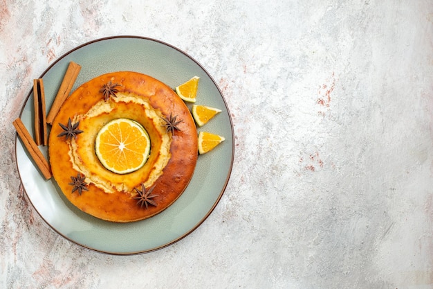 Top view yummy round pie delicious dessert for tea with orange slices on the white background fruit cake pie biscuit tea sweet dessert