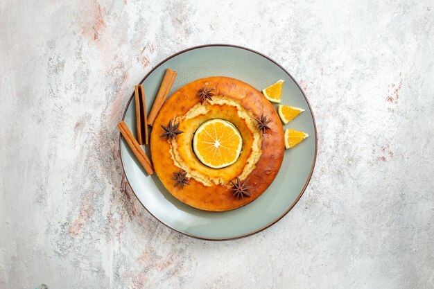 Top view yummy round pie delicious dessert for tea with orange slices on white background fruit cake pie biscuit tea sweet dessert