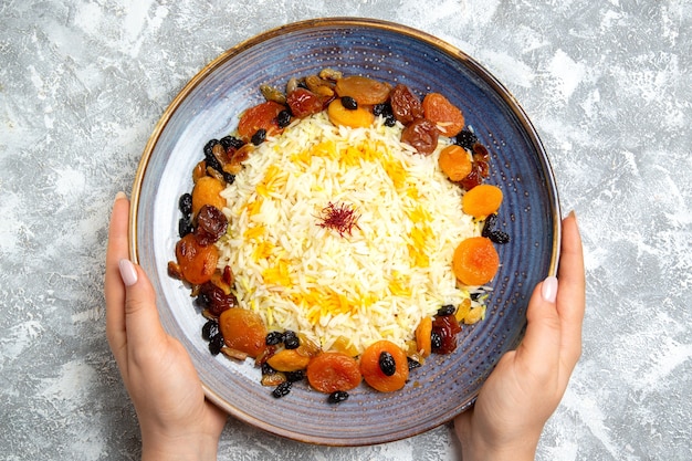 Free Photo top view yummy shakh plov cooked rice dish with raisins inside plate on a light-white