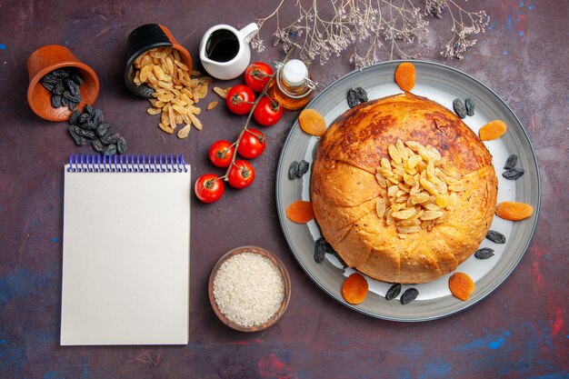 Top view yummy shakh plov cooked rice meal inside dough with tomatoes on a dark background rice meal food dinner cooking