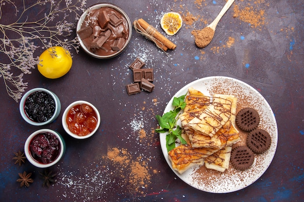 Top view yummy sweet pastries with cookies and jam on dark background cookie biscuit sugar tea sweet cake