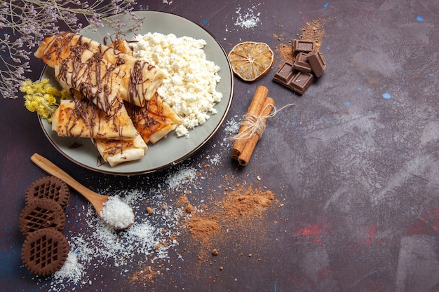 Free Photo top view yummy sweet pastries with cottage cheese and cookies on dark background cookie biscuit sugar sweet cake tea