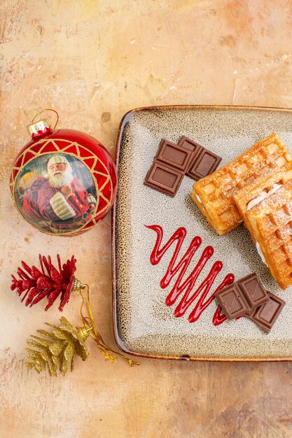 Free photo top view yummy waffle cakes with chocolate bars on the brown background