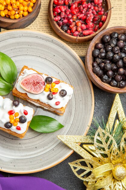 Top view yummy waffle cakes with fresh fruits on dark background