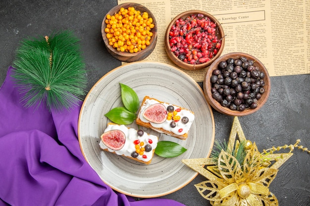 Top view yummy waffle cakes with fresh fruits on the dark background