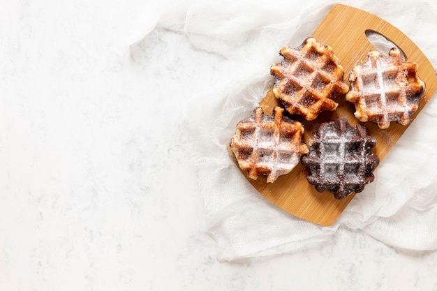 Free Photo top view yummy waffles on white background