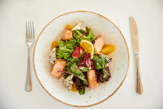 Topview of a served pork salad  with cheese and lettuce