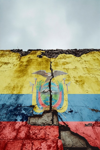 Free photo torn and broken flag of ecuador on cement wall