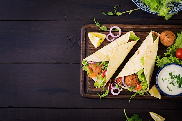 Free Photo tortilla wrap with falafel and fresh salad. vegan tacos. vegetarian healthy food. top view