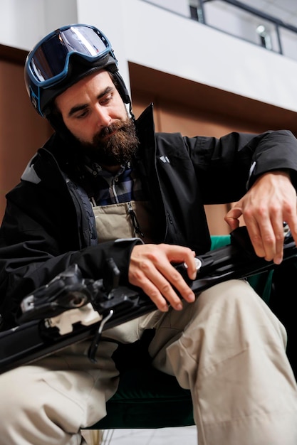 Free photo tourist checks ski gear in hotel foyer