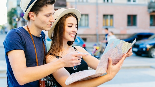 Tourist couple looking at map