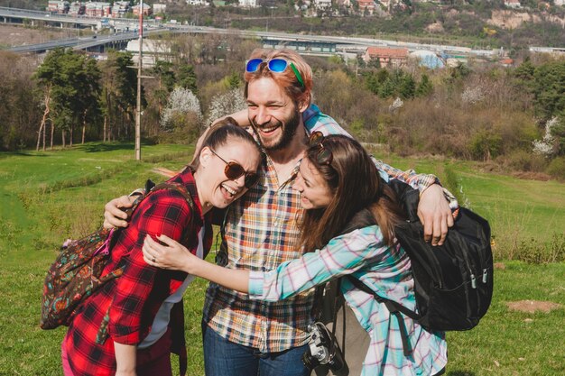 Tourist friends hugging each other