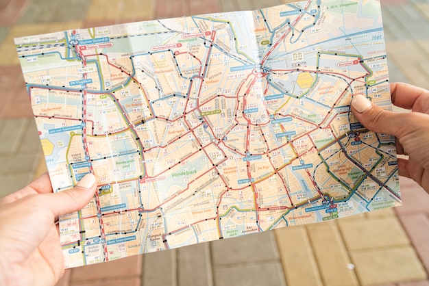 Tourist holding a map on street