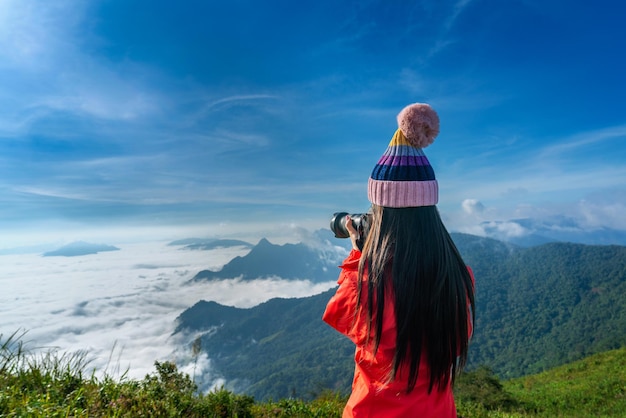 Tourist taking photographs with digital camera in a mountains. Phu chi fa mountains in Chiang Rai, Thailand.