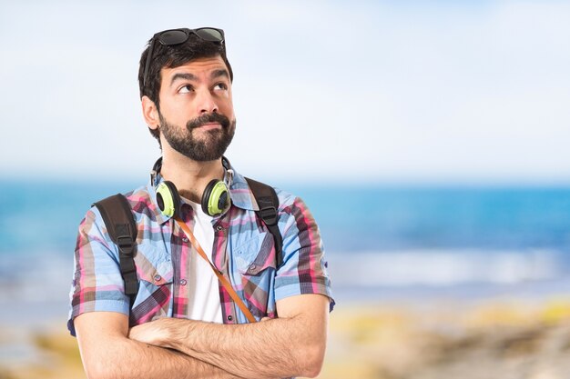 Tourist thinking over white background