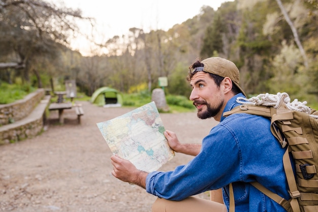 Free photo tourist with map in nature