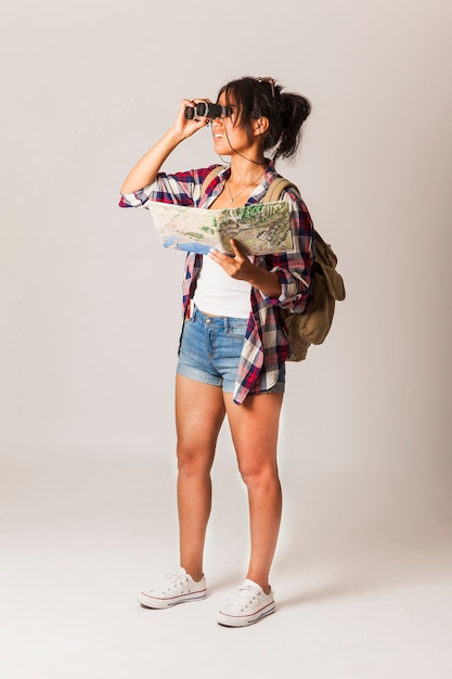 Tourist woman looking through binoculars