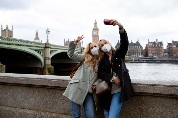 Tourists visiting city and wearing travel mask