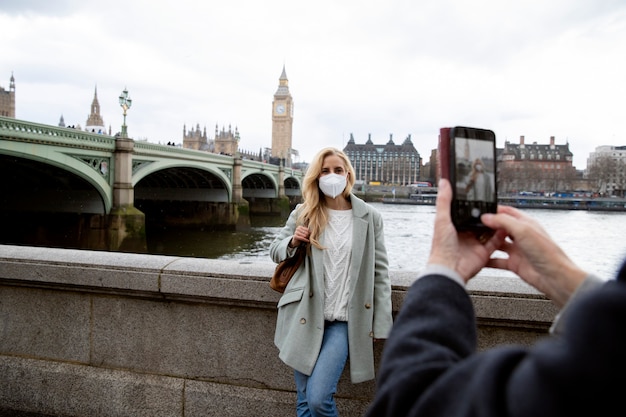 Tourists visiting city and wearing travel mask