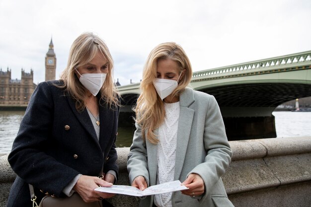 Tourists visiting city and wearing travel mask