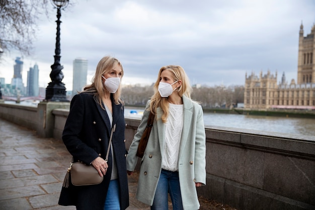 Tourists visiting city and wearing travel mask