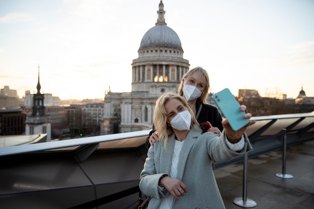 Tourists visiting city and wearing travel mask