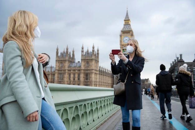 Tourists visiting city and wearing travel mask