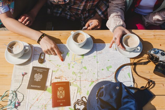 Tourists with coffee and map