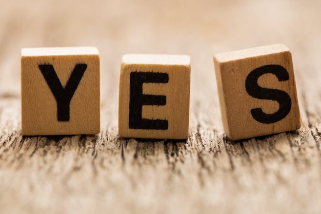 Toy bricks on the table with word yes