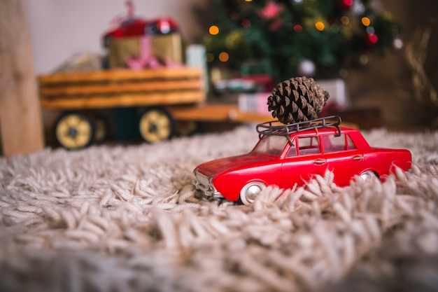 Free Photo toy car with a pine cone