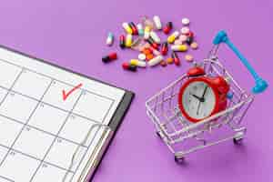 Free photo toy cart with clock and pills beside on desk