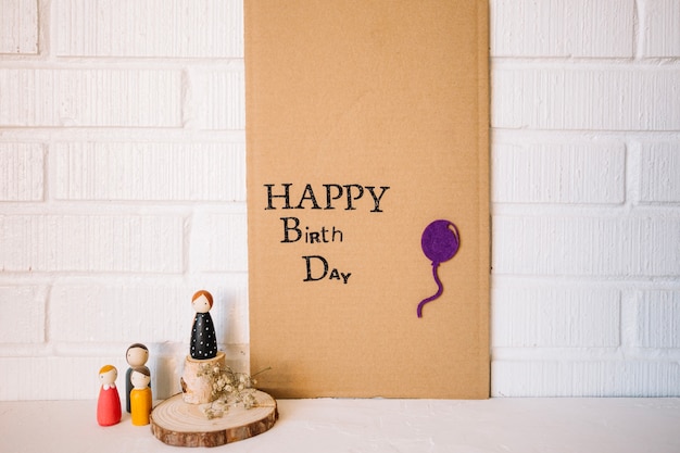 Free Photo toy figures near cardboard with birthday writing