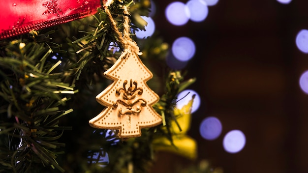 Free photo toy fir tree hanging on christmas tree