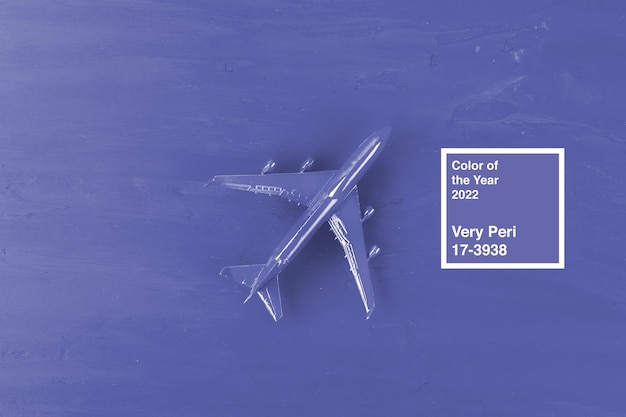 Toy plane on dark purple background top view