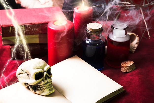 Toy skull on book with Halloween decorations